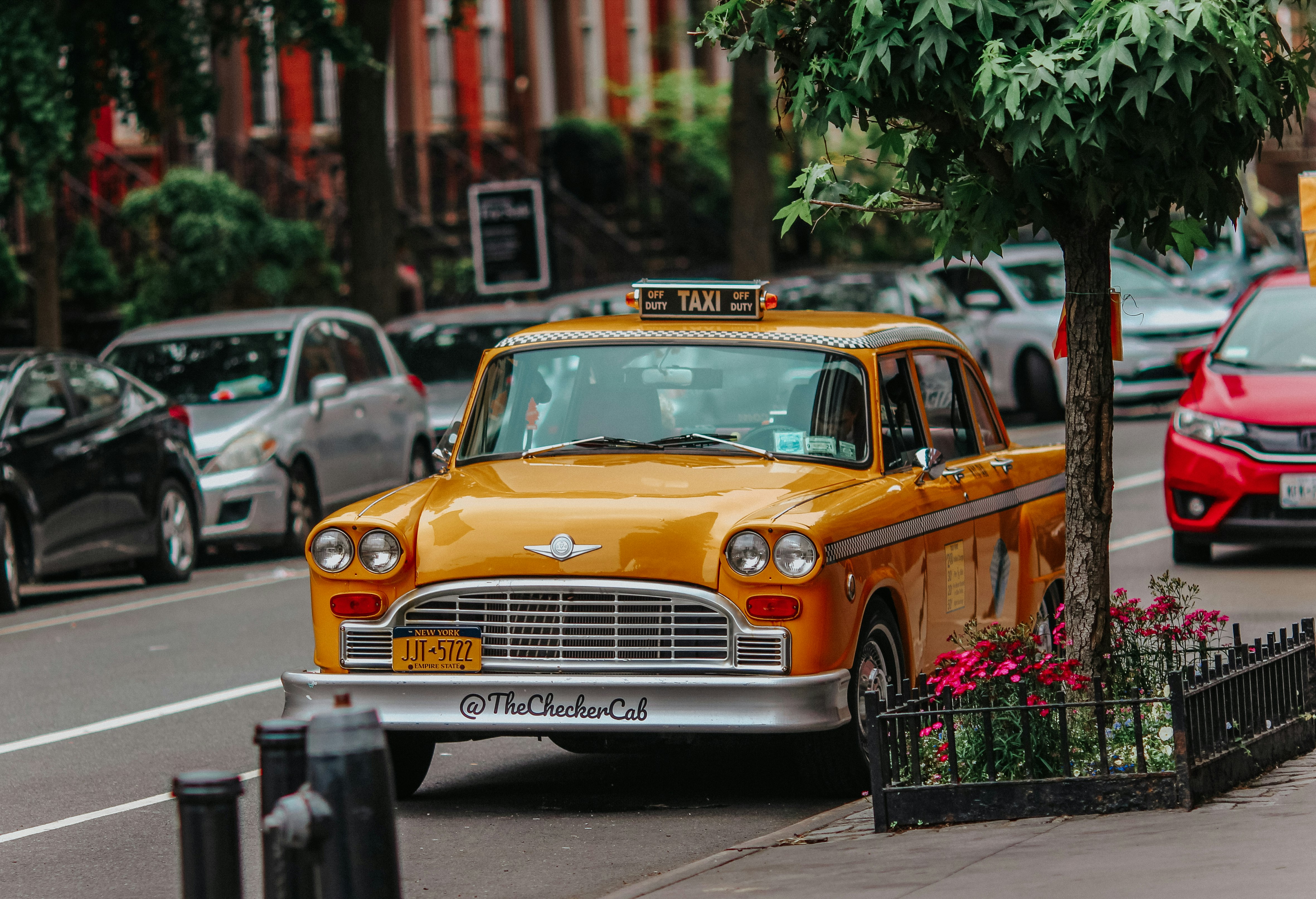 yellow taxi cab on the street during daytime